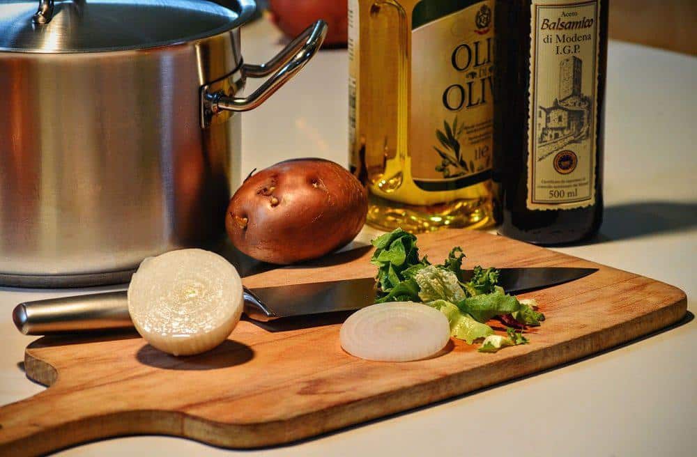 COOKING WITH ONION AND OLIVE OIL AND KNIFE
